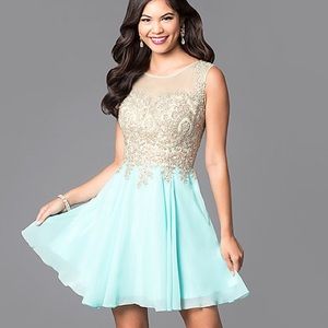 Elizabeth K. Gold and teal short dress.